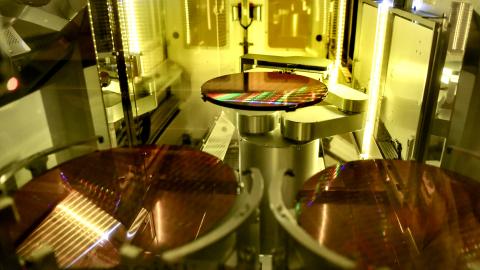 Semiconductor chips are printed onto silicon wafers and loaded into containers in the clean room at GlobalFoundries Fab 8 in Malta, New York, on June 10, 2021. (Cindy Schultz via Getty Images)