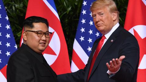 US President Donald Trump (R) gestures as he meets with North Korea's leader Kim Jong Un (L) at the start of their historic US-North Korea summit, at the Capella Hotel on Sentosa island in Singapore on June 12, 2018. (Saul Loeb via Getty Images)