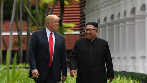 North Korea's leader Kim Jong Un walks with US President Donald Trump during a break in talks at their historic US-North Korea summit, at the Capella Hotel on Sentosa island in Singapore on June 12, 2018. (Saul Loeb via Getty Images)