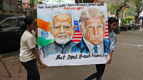 2025/08/01: Students from Gurukul School of Art carry a poster of Prime Minister of India Narendra Modi and U.S. President Donald Trump outside their school. U.S. President Donald Trump imposed a 25% tariff on India along with penalties for buying oil and military equipments from Russia. (Photo by Ashish Vaishnav/SOPA Images/LightRocket via Getty Images)