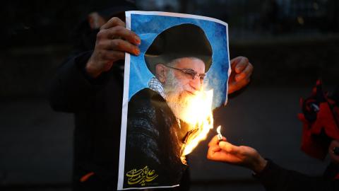 Protesters burn an image of Ayatollah Ali Khamenei during a gathering outside the Iranian embassy in central London on January 12, 2026. (Getty Images)