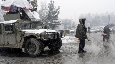 Taliban security personnel stand guard at a checkpoint during snowfall in Kabul on January 22, 2026. (Getty Images) Share to Twitter