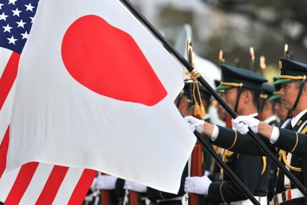 A unit of the Japanese Ground Self Defense Force honor guards hold national flags for visiting US Army General Martin E. Dempsey, chairman of the Joint Chiefs of Staff at the Defence Ministry in Tokyo on October 28, 2011. (KAZUHIRO NOGI/AFP/Getty Images)