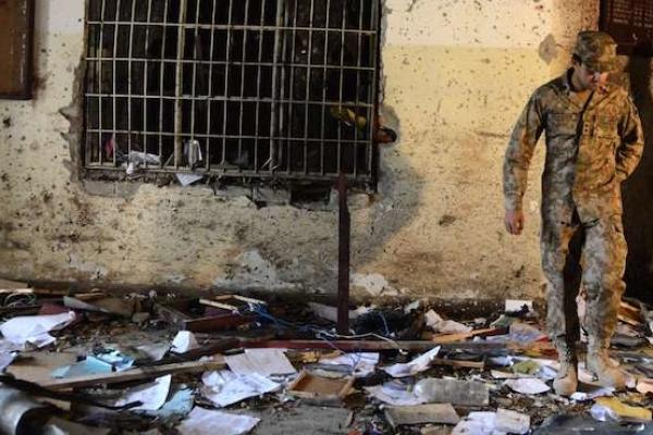 A Pakistani soldier walks amidst the debris in an army-run school a day after an attack by Taliban militants in Peshawar on December 17, 2014. (A Majeed/AFP/Getty Images)