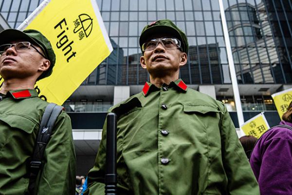 Protesters dress up as members of the Chinese Liberation Army (PLA) at the recently reopened Civic Square as they take part in the annual New Year's Day pro-democracy rally in Hong Kong on January 1, 2018.  