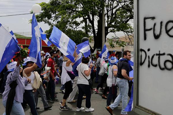 People attend the 'Marcha de las Flores' -in honor of the children killed during protests- in Managua on June 30, 2018 
