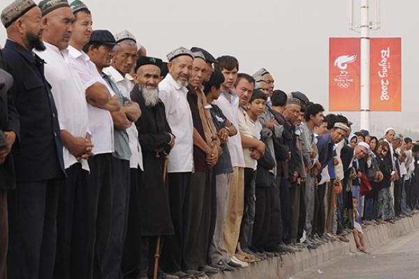 Ethnic Uyghurs forced to attend memorial ceremony for Chinese police officers killed in a terrorist attack in Xinjiantg, August 7, 2008 