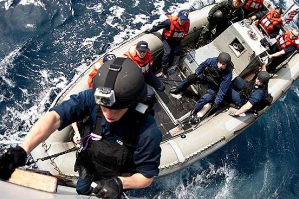 A visit, board, search, and seizure team member from the guided-missile destroyer USS Lassen DDG-82 boards the Republic of Korea navy combat support ship ROKS Chonji AOE-57 with Republic of Korea SEAL/UDT Team members during a joint training mission.