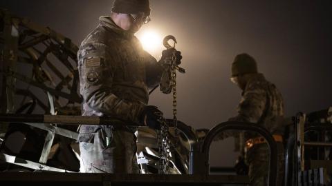 Senior Airmen Davonte Martinez, left, and Victor Davis, right, both 436th Aerial Port Squadron ramp operation specialists, load cargo during a security assistance mission at Dover Air Force Base, Delaware, Jan. 20, 2023. The Department of Defense is providing Ukraine with critical capabilities to defend against Russian aggression. (U.S. Air Force photo by Staff Sgt. Marco A. Gomez)