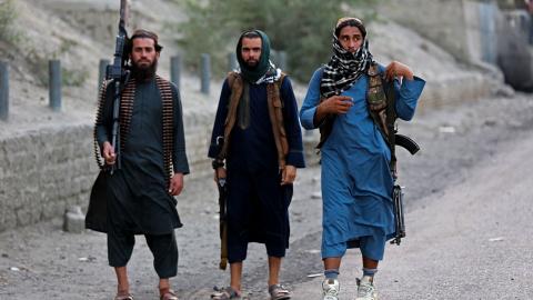 Armed Taliban security personnel near the closed gates of a border crossing between Afghanistan and Pakistan in Nangarhar, Afghanistan, on September 6, 2023. (Shafiullah Kakar/AFP via Getty Images)