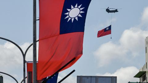 A CH-47 Chinook helicopter carries a Taiwan flag during National Day celebrations in Taipei on October 10, 2021. (Sam Yeh/AFP via Getty Images)