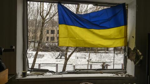 A Ukrainian flag is hanging in the window of an apartment building that has been heavily damaged during Russia's massive rocket attack on Kyiv, in Kyiv, Ukraine, on January 3, 2024. (Maxym Marusenko/NurPhoto via Getty Images)