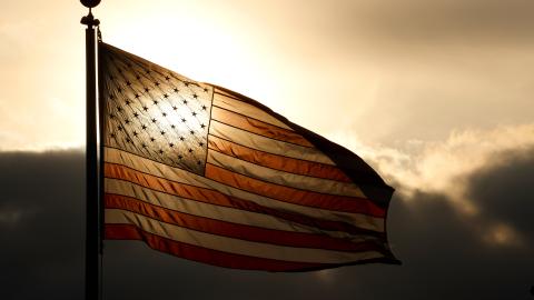 The sun sets behind an American flag flying at the Tear Drop 9/11 Memorial on May 12, 2024, in Bayonne, New Jersey. (Photo by Gary Hershorn/Getty Images)