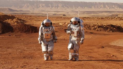 Astronauts from Europe and Israel walk in spacesuits during a training mission for planet Mars in the Negev desert on October 10, 2021. (Jack Guez/AFP via Getty Images)