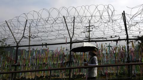 A woman walks past prayer ribbons wishing for reunification of the two Koreas on July 19, 2023, in Paju, South Korea. (Chung Sung-Jun via Getty Images)