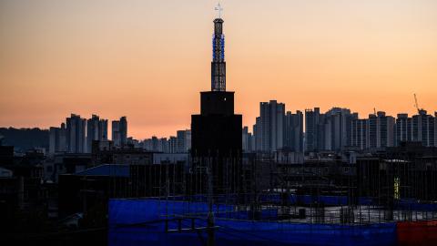 A general view shows a church (C) between a construction site (foreground) and residential and commercial buildings in Seoul on November 21, 2023. (Photo by Anthony WALLACE / AFP) (Photo by ANTHONY WALLACE/AFP via Getty Images)