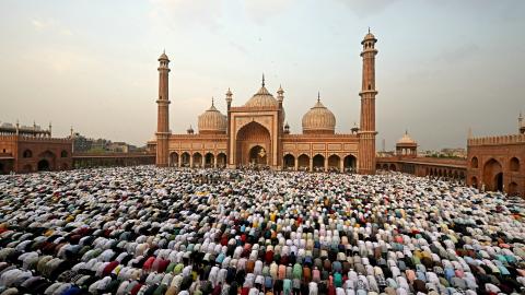 Muslim devotees offer Eid al-Fitr prayers in the old quarters of New Delhi on April 11, 2024. (Money Sharma/AFP via Getty Images)