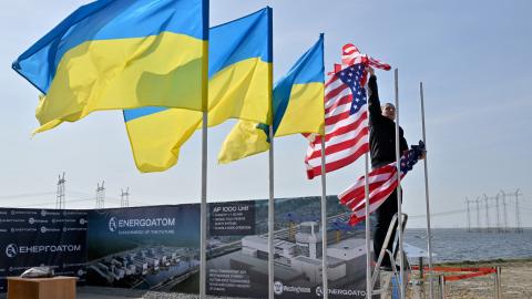 An employee hangs flags near Khmelnytsky, Ukraine, on April 11, 2024. (Sergei Supinsky/AFP via Getty Images)