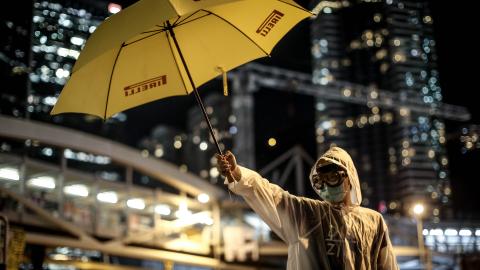 A pro-democracy activists stands with a yellow umbrella as part of an art installation outside Hong Kong's Government complex on October 9, 2014. (Photo by Chris McGrath/Getty Images)