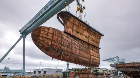 The final piece of the underwater hull of the USS John F. Kennedy (CVN 79) is lowered into place at Huntington Ingalls Industries Newport News Shipbuilding in Virginia on September 28, 2018. (US Navy photo courtesy of Huntington Ingalls Industries by John Whalen)