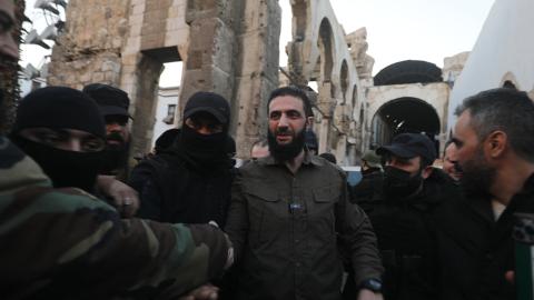 Abu Mohammed al-Jolani, the leader of Syria's Islamist Hayat Tahrir al-Sham group, is welcomed by supporters at the capital's landmark Umayyad Mosque in Damascus, Syria, on December 8, 2024. (Abdulaziz Ketaz/AFP via Getty Images)