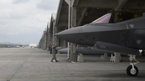 US Air Force Airman 1st Class Austin House, 388th Aircraft Maintenance Squadron crew chief,  marshals an F-35A Lightning II from underneath a hardened facility on January 24, 2018, at Kadena Air  Base, Japan. (US Air Force)