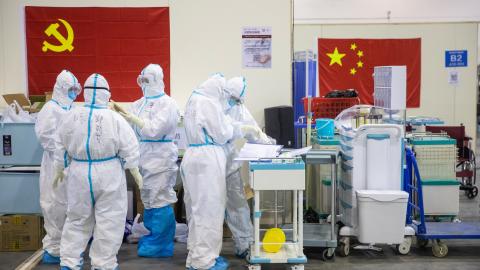 This photo taken on February 17, 2020 shows medical staff members working at an exhibition centre converted into a hospital in Wuhan in China's central Hubei province (Photo by STR/AFP via Getty Images)