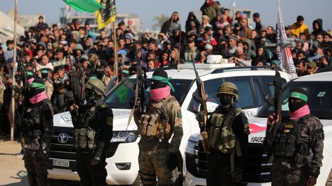 People watch as they secure an area before handing over Israeli hostages to a Red Cross team in Khan Yunis in the southern Gaza Strip on February 15, 2025. (Getty Images)