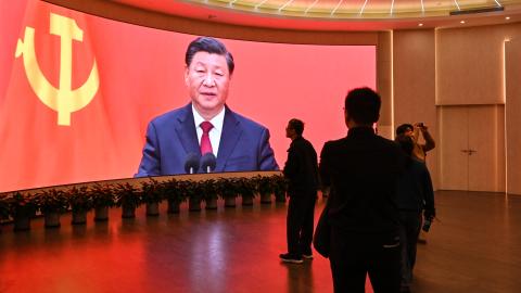 A screen shows images of China's President Xi Jinping in Shanghai on February 27, 2025. (Hector Retamal/AFP via Getty Images)