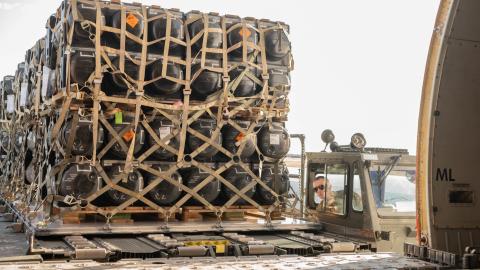 A US airman loads ammunition, weapons, and other equipment bound for Ukraine during a foreign military sales mission at Dover Air Force Base, Delaware, on February 10, 2022. (US Air Force photo by Mauricio Campino)