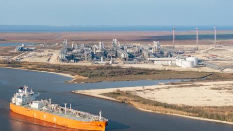 An aerial view of a cargo ship passing by the Cheniere Energy liquefied natural gas plant on February 10, 2025 in Port Arthur, Texas. China, the world's largest importer of liquefied natural gas, has announced that it will be placing a 15% tariff on U.S. liquefied natural gas in retaliation to President Trump's ruling to impose tariffs on Chinese commodities. (Photo by Brandon Bell/Getty Images)