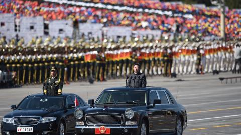 Chinese President Xi Jinping inspects troops during a parade commemorating the seventieth anniversary of the end of World War II in Beijing on September 3, 2015. (Huang Xiaobang via Getty Images)