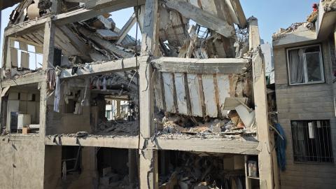 People look over damage to buildings following Israeli airstrikes on June 13, 2025, in Tehran, Iran. (Majid Saeedi via Getty Images)