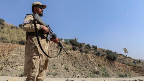 A Taliban security officer stands guard along a road near the Ghulam Khan border crossing between Afghanistan and Pakistan on October 20, 2025. (Getty Images)