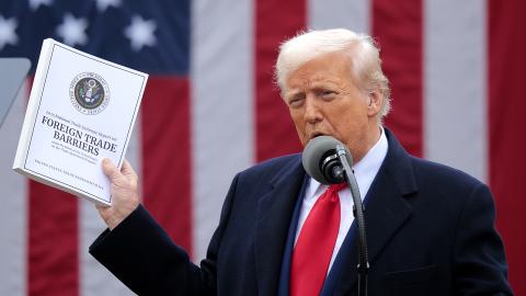  U.S. President Donald Trump holds up a copy of a 2025 National Trade Estimate Report as he speaks during a “Make America Wealthy Again” trade announcement event in the Rose Garden at the White House on April 2, 2025 in Washington, DC. Touting the event as “Liberation Day”, Trump is expected to announce additional tariffs targeting goods imported to the U.S. (Photo by Chip Somodevilla/Getty Images)