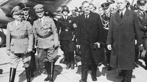 British Prime Minister Neville Chamberlain, German Foreign Minister Joachim von Ribbentrop, and General Franz von Epp leave the Munich Airport on September 30, 1938, for the Four Power Conference in Munich to decide the question of Czechoslovakia.