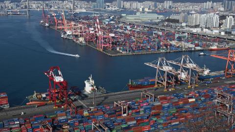 Containers are stacked on ships at a terminal in the port of Busan, South Korea, on February 18, 2026. (Getty Images)