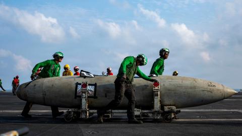 U.S. Sailors transport a fuel tank on the flight deck of Nimitz-class aircraft carrier USS Abraham Lincoln (CVN 72) during Operation Epic Fury, March 21, 2026. (U.S. Navy photo)