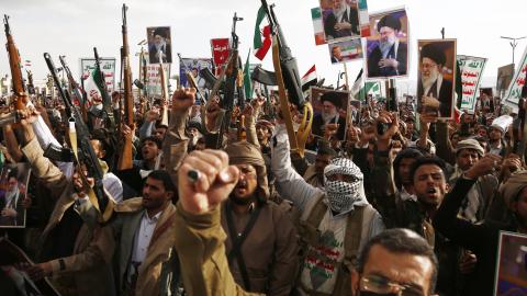 Pro-Iran protesters brandish billboards depicting the Iranian Supreme Leader Ali Hosseini Khamenei, flags of Yemen and Iran, weapons, and chant slogans as they take part in a rally on March 1, 2026, in Sana'a, Yemen. (Getty Images) Share to Twitter
