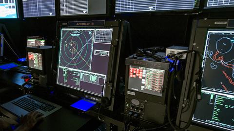 An Air Traffic Controller monitors computer screens inside the Carrier Air Traffic Control Center (CATCC) used with the US Navy's Northrop Grumman X-47B, July 31, 2012 at Naval Air Station Patuxent River, Maryland.