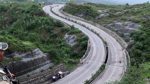 Indian security personnel stand guard overlooking the Jammu-Srinagar highway in Nagrota near Jammu. (Getty Images)