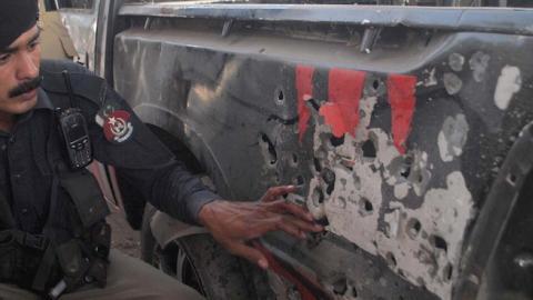 A police officer inspects a vehicle after a bomb went off near Gulbahar Police Station in Peshawar, Pakistan, April 24, 2015. Tehreek-e-Taliban Pakistan (TTP) have claimed responsibility for the attack. (Asianet-Pakistan / Barcroft Indi via Getty Images)