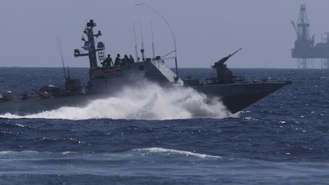 An Israeli Navy vessel passes by the Tamar drilling natural gas production platform during a squadron exercise on May 27, 2013 off the coast of Israel in the Mediterranean Sea. (Uriel Sinai/Getty Images)