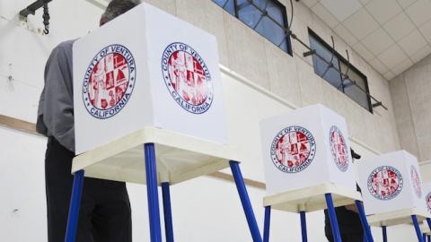 Citizen votes in election booth polling station in a gymnasium in Oak View, California, on November 4, 2014. (Joseph Sohm / Shutterstock.com)