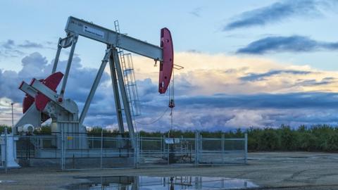 A pump jack and surface water at oil well and fracking site in Shafter, over the Monterey Shale, San Joaquin Valley, California. (Citizens of the Planet/Education Images/UIG via Getty Images)