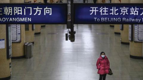 A Chinese woman wears a protective mask in Beijing, Feb. 3.