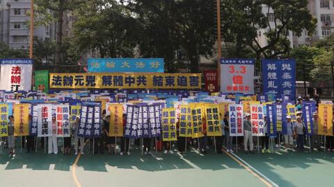 Members of the Falun Gong spiritual group, a group banned in mainland China, gather to protest at a playground in the Sham Shui Po district in Hong Kong on October 1, 2019. (Photo by MAY JAMES/AFP via Getty Images)