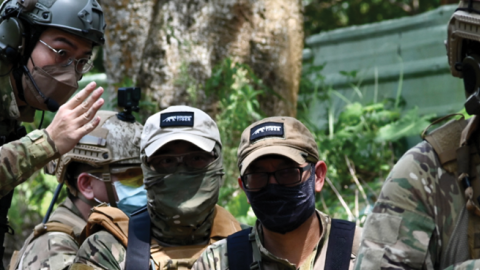  Taiwanese civilians in tactical gear and replica weapons taking part in an urban warfare workshop on June 18 in Linko district, New Taipei City. (Photo by Sam Yeh / AFP)