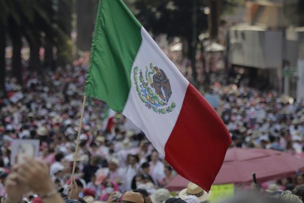 A Mexican flag waves on the esplanade of the Monument to the Revolution in Mexico City on November 13, 2022. (Photo by Gerardo Vieyra/NurPhoto via Getty Images)