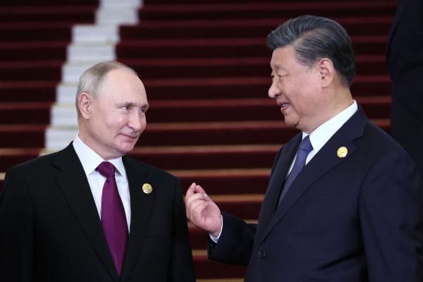 .Russian President Vladimir Putin and Chinese President Xi Jinping interacting in Beijing on October 17, 2023. (Sergei Savostyanov/POOL/AFP via Getty Images)